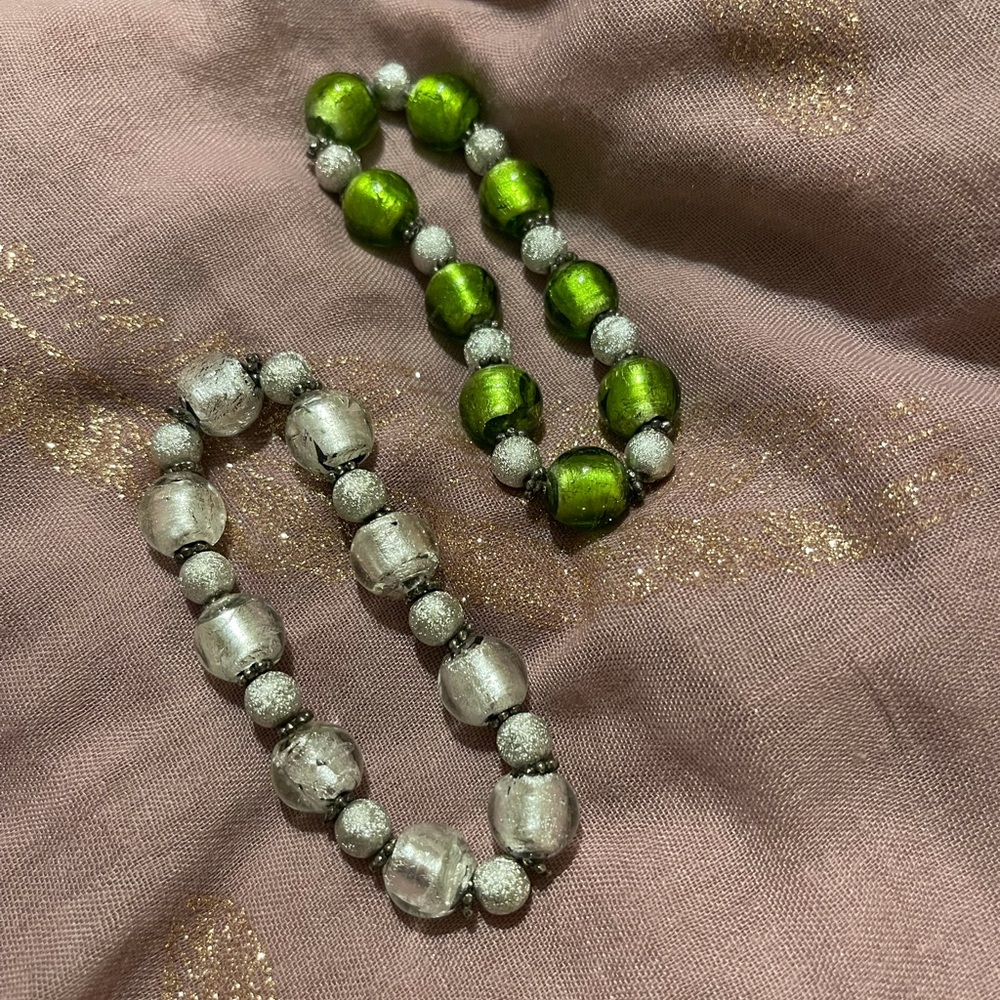 Gorgeous, glass beaded bracelets with glittering silver-tone spacers.